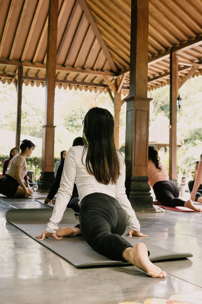 Experience outdoor group yoga at a serene pavilion in Jawa Barat, Indonesia. Perfect for relaxation and fitness.
